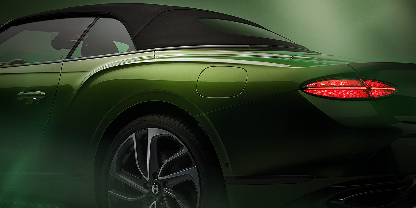 Bentley Jeddah Bentley New Continental GTC Speed rear haunch and tail lamp in Tourmaline Green paint and dark tint brightware with black hood up and illuminated head lamps