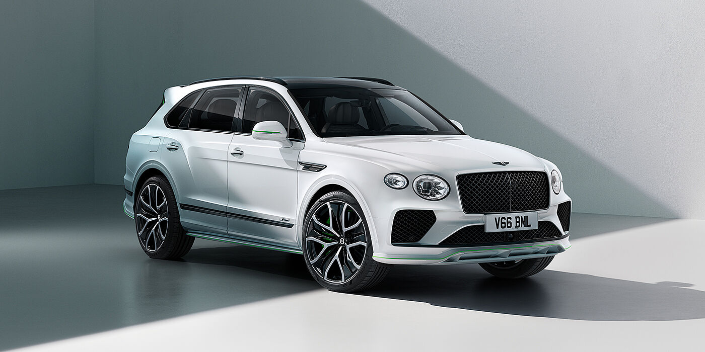 Bentley Jeddah Bentley Bentayga Speed SUV front three quarter in Snow Quartz Pearlescent by Mulliner white paint against a grey wall