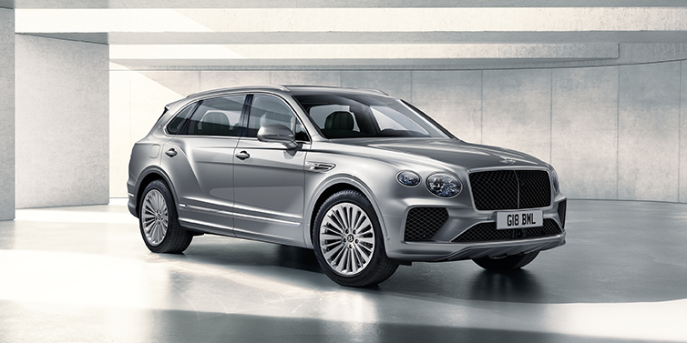 Bentley Jeddah Bentley Bentayga Extended Wheelbase SUV front three quarter in Moonbeam paint with a grey background