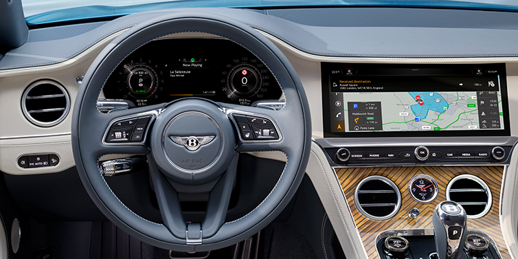 Bentley Jeddah New Bentley Continental GT Azure coupe front interior in Linen and Brunel blue hides, showing steering wheel and driver's instruments